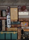 Rebel Walls Carta da parati panoramica Stacked Suitcases - Heap